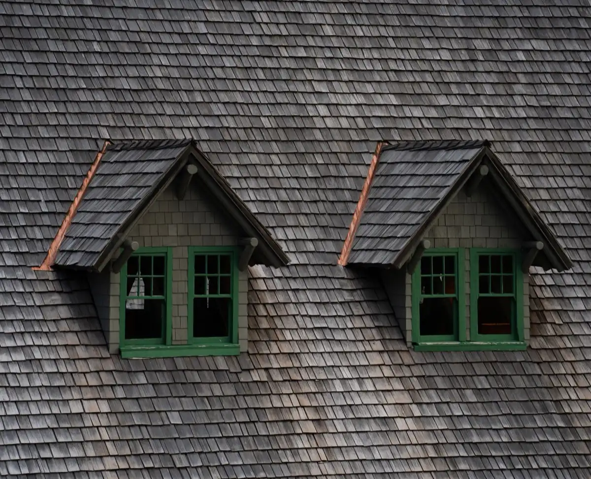 Dormers on a shingle roof in Kent, WA, where step flashing and kickout flashing carry water past the walls